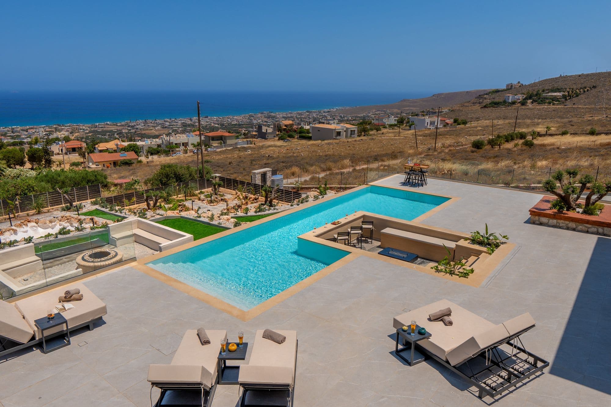 Expansive infinity pool with mountain and sea views overlooking Cretan landscape